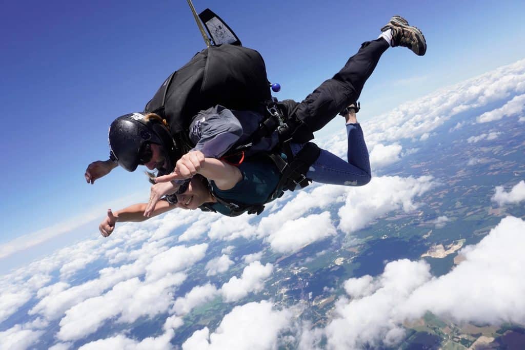 man and woman skydiving through clouds in Franklinton, NC